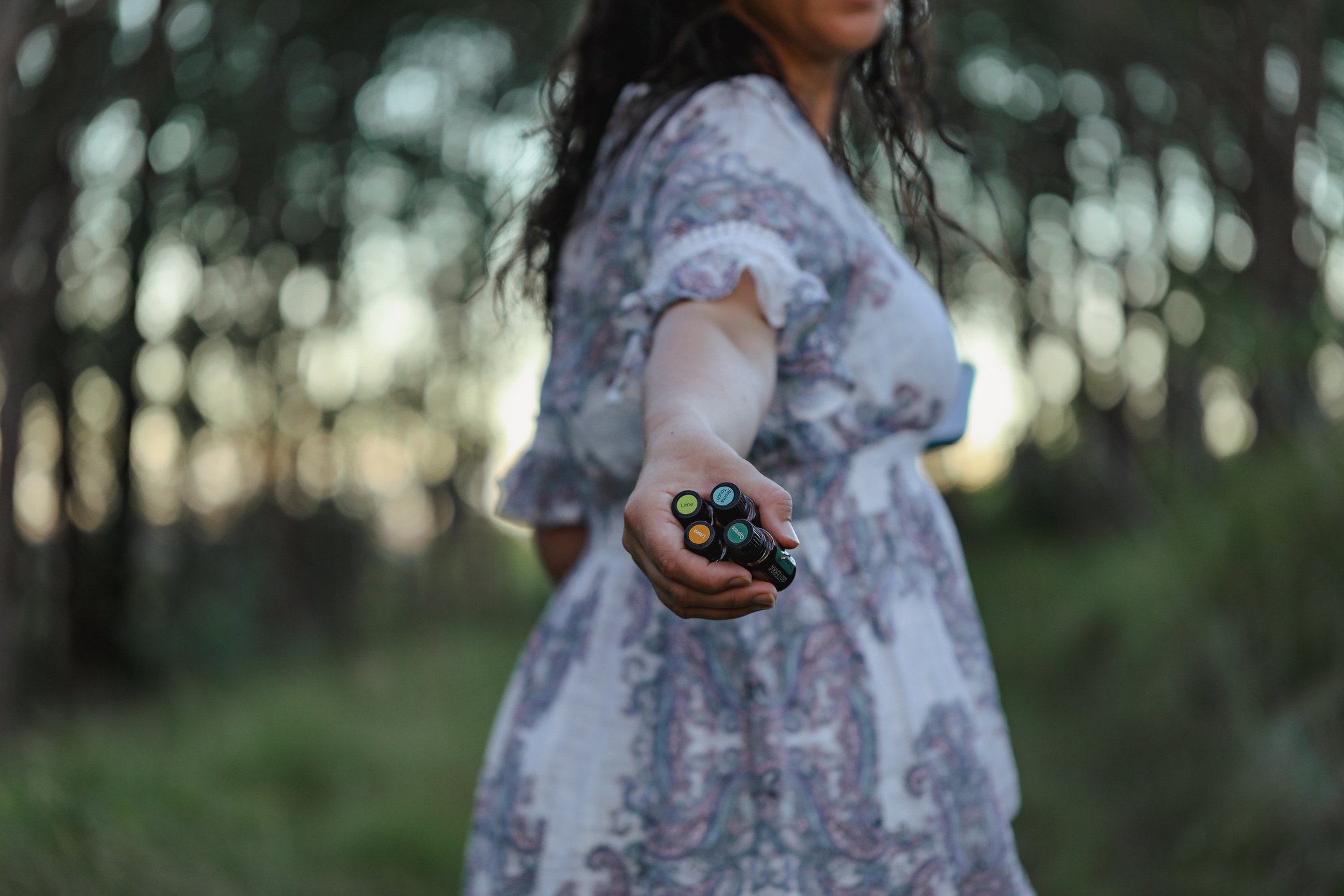 Firefly NSW Australia - 20 April 2022: Woman in Forest Holding Bundle of Doterra Essential Oils